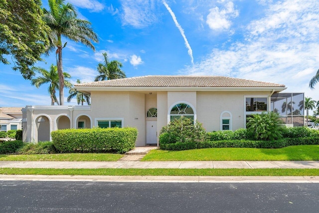 mediterranean / spanish-style home featuring a front yard