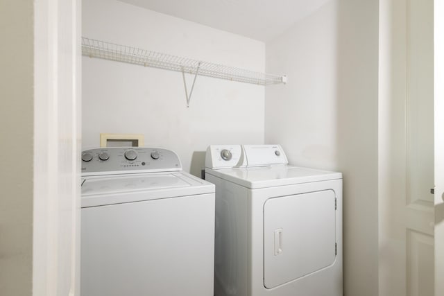 clothes washing area with independent washer and dryer