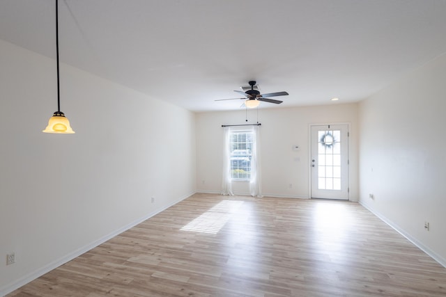 spare room featuring ceiling fan and light hardwood / wood-style flooring