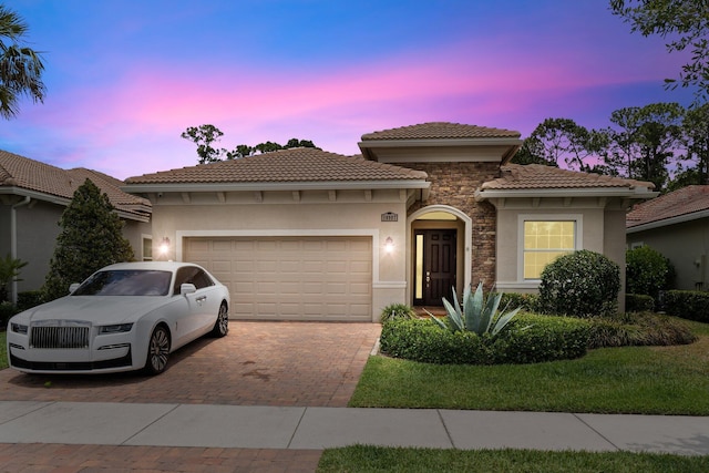 mediterranean / spanish house featuring a garage