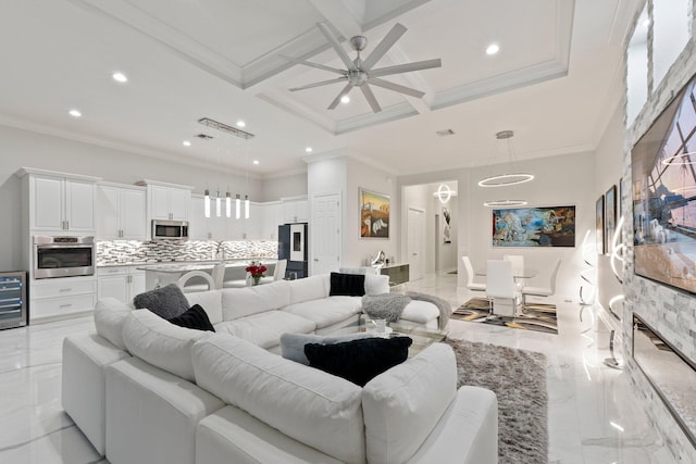 living room featuring light tile patterned flooring, ceiling fan, ornamental molding, and coffered ceiling