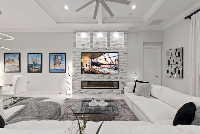 living room with ornamental molding, a fireplace, ceiling fan, and a raised ceiling