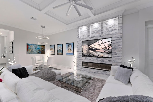 living room with ceiling fan, ornamental molding, coffered ceiling, and a large fireplace