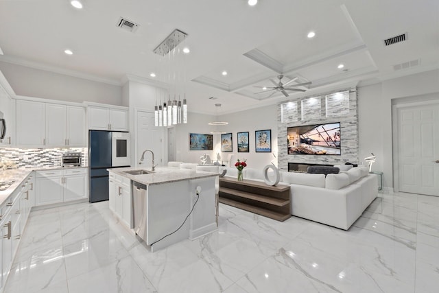 kitchen with ceiling fan, white cabinets, an island with sink, coffered ceiling, and appliances with stainless steel finishes