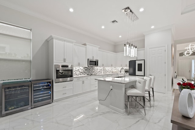 kitchen featuring sink, light stone countertops, stainless steel appliances, and wine cooler