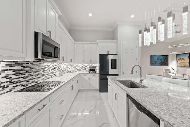 kitchen featuring sink, crown molding, appliances with stainless steel finishes, white cabinetry, and decorative light fixtures