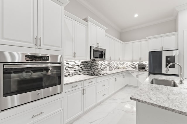 kitchen with sink, crown molding, stainless steel appliances, and white cabinets