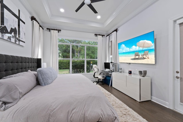 bedroom with crown molding, ceiling fan, dark hardwood / wood-style floors, and a tray ceiling