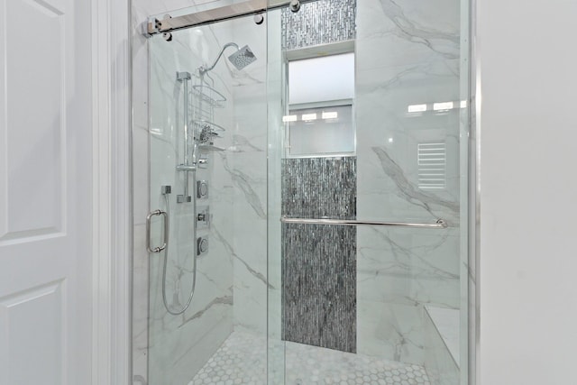 bathroom featuring a shower with door