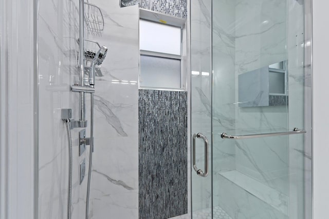 bathroom with a shower with shower door