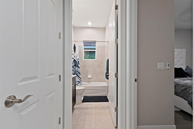 full bathroom featuring tiled shower / bath, vanity, tile patterned floors, and toilet