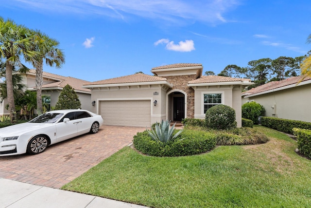 mediterranean / spanish-style home with a garage and a front yard