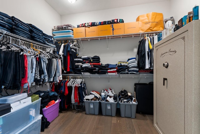 walk in closet with hardwood / wood-style floors