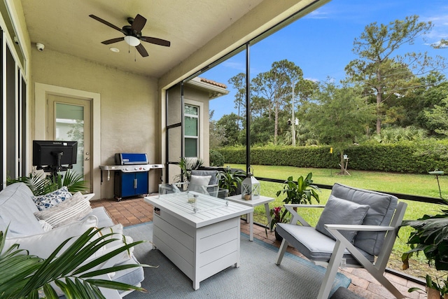 sunroom featuring ceiling fan