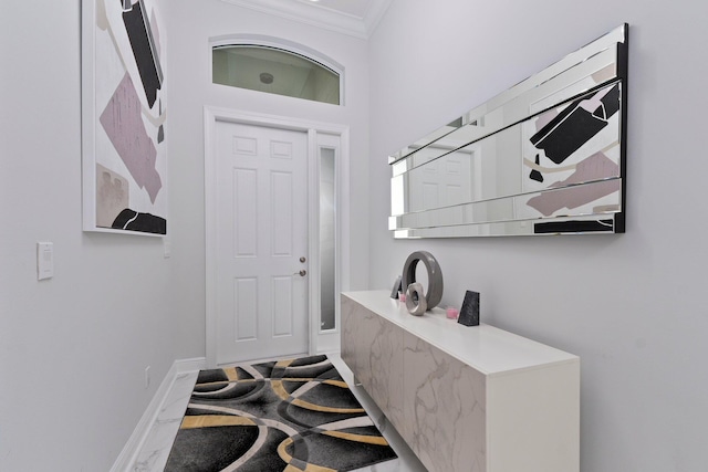 foyer entrance featuring ornamental molding