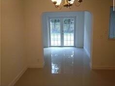 unfurnished dining area with an inviting chandelier