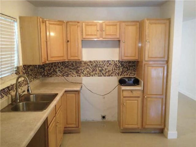 kitchen featuring tasteful backsplash, sink, and light brown cabinetry