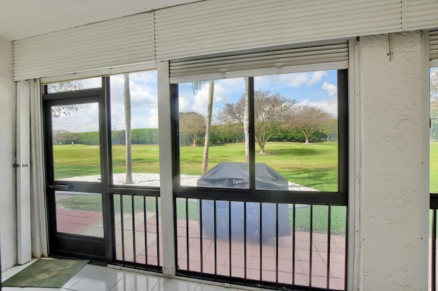 doorway to outside with a healthy amount of sunlight and tile patterned flooring