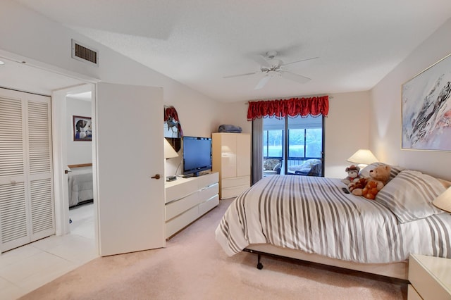 bedroom with visible vents, a ceiling fan, and light colored carpet