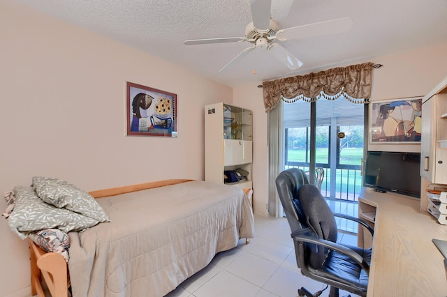 tiled bedroom with access to outside, a textured ceiling, and ceiling fan