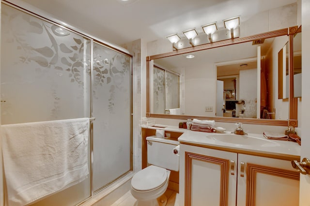bathroom with vanity, tile patterned flooring, a shower stall, and toilet