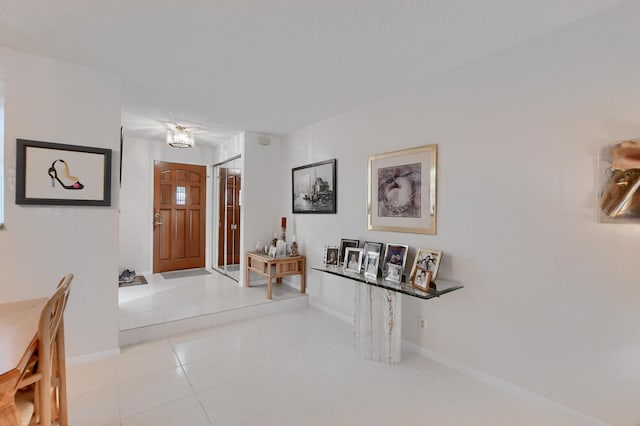 entryway with tile patterned floors and baseboards