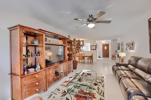 living area featuring visible vents, a textured ceiling, ceiling fan, and light tile patterned flooring