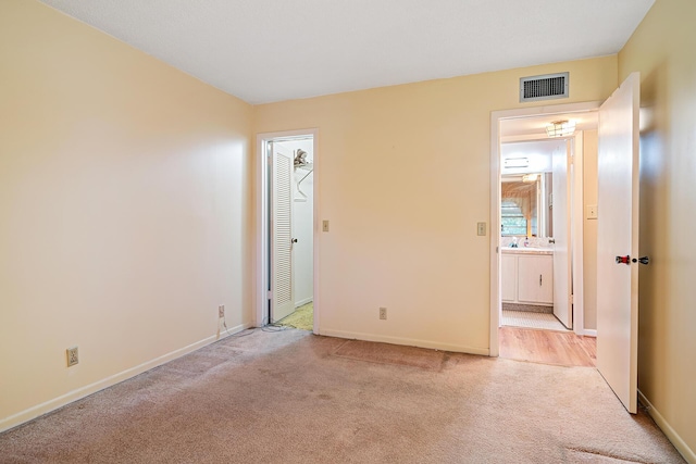 carpeted spare room featuring sink