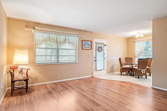 entryway with a textured ceiling and light hardwood / wood-style flooring