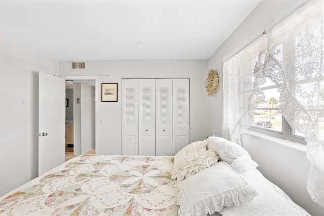 bedroom featuring visible vents and a closet