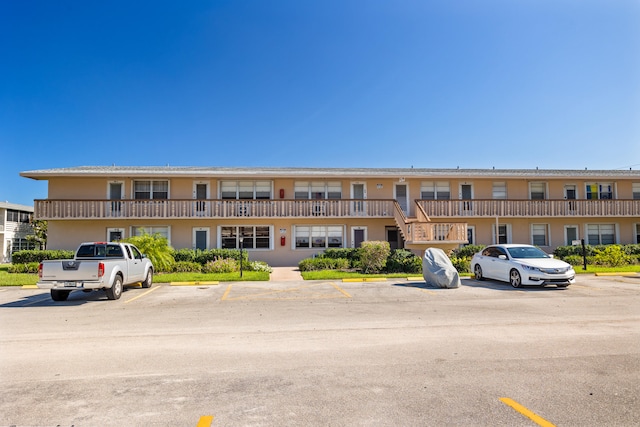 view of property featuring uncovered parking