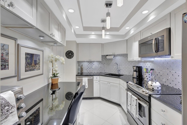 2000 Presidential Way Unit Ph5, West Palm Beach, FL 33401 - kitchen featuring appliances with stainless steel finishes, decorative backsplash, recessed lighting, light tile patterned flooring, and decorative light fixtures