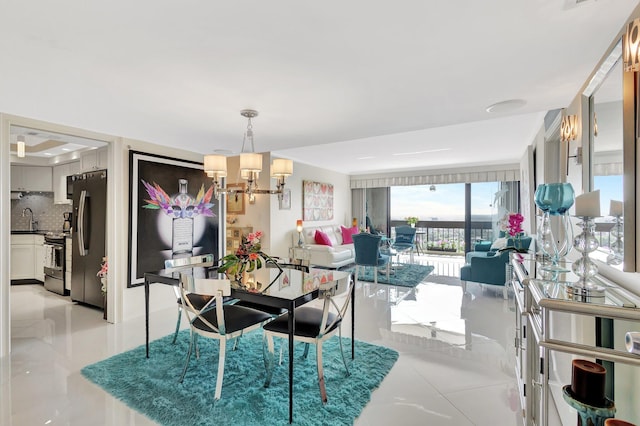2000 Presidential Way Unit Ph5, West Palm Beach, FL 33401 - dining area featuring light tile patterned flooring and a chandelier