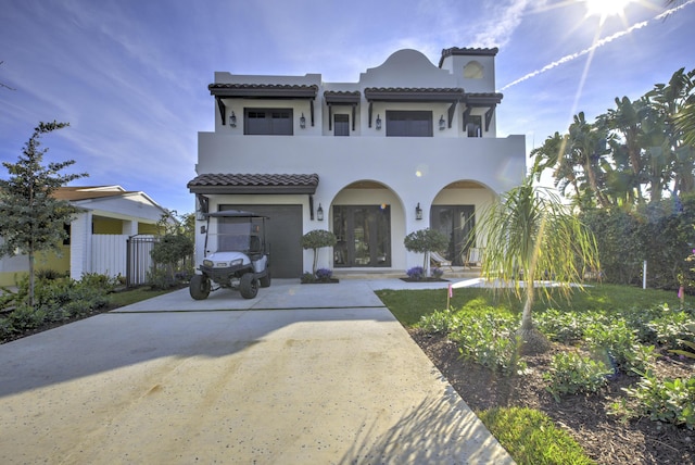 mediterranean / spanish house with french doors and a balcony