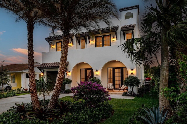 226 NE 11th St, Delray Beach, FL 33444 - mediterranean / spanish house with stucco siding, concrete driveway, a tile roof, and a garage