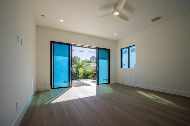 spare room featuring ceiling fan and dark wood-type flooring