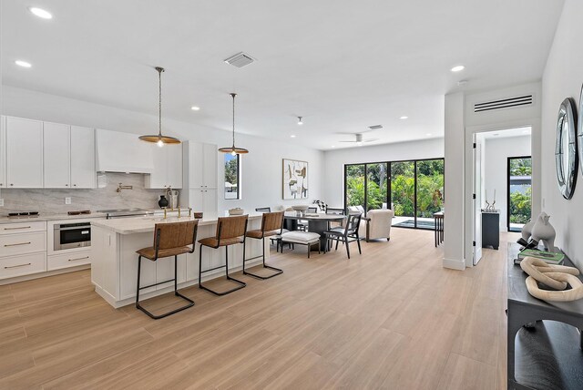 226 NE 11th St, Delray Beach, FL 33444 - kitchen featuring a sink, open floor plan, recessed lighting, an island with sink, and decorative light fixtures