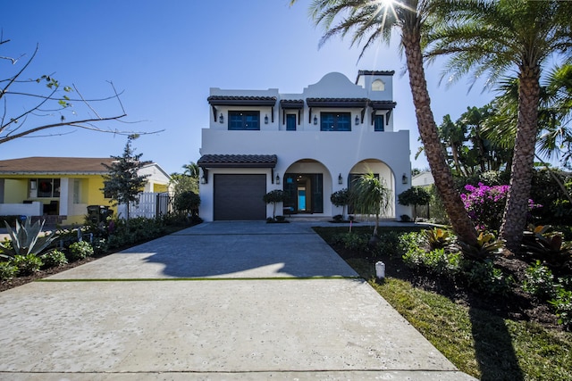 mediterranean / spanish-style home with a garage