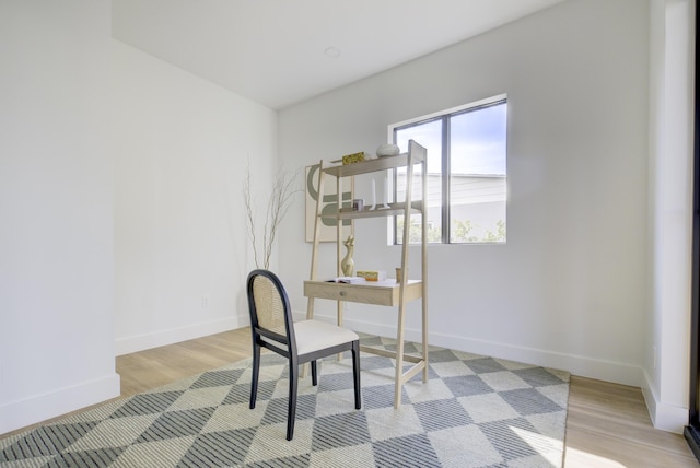 home office with light hardwood / wood-style flooring