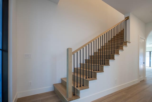 stairs with hardwood / wood-style flooring