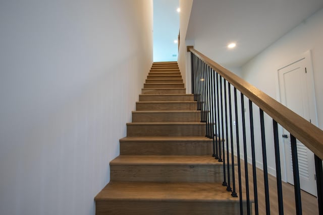 stairway featuring wood-type flooring