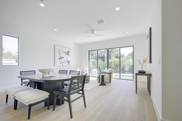 dining space with a wealth of natural light, light hardwood / wood-style floors, and ceiling fan