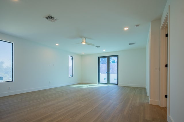 spare room featuring french doors, ceiling fan, and light hardwood / wood-style floors