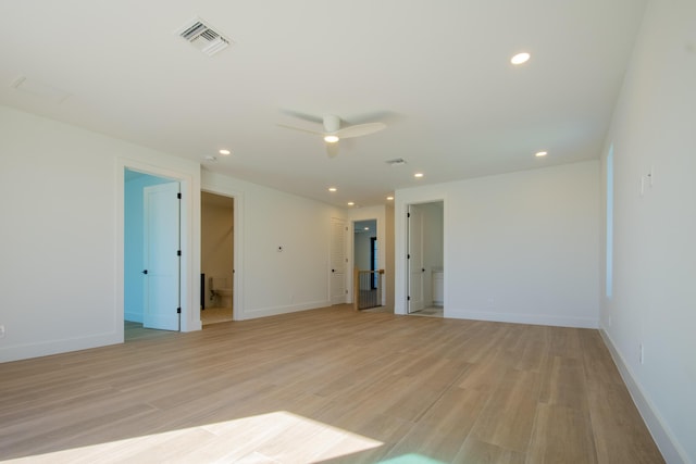 empty room with ceiling fan and light hardwood / wood-style floors