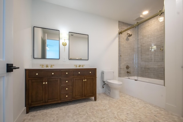 full bathroom featuring bath / shower combo with glass door, vanity, and toilet