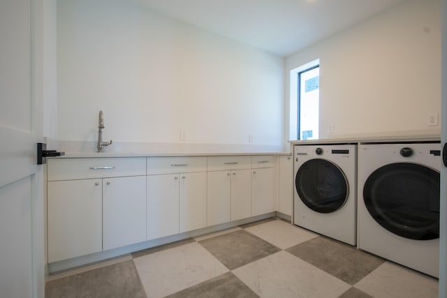 washroom featuring sink, cabinets, and washer and clothes dryer