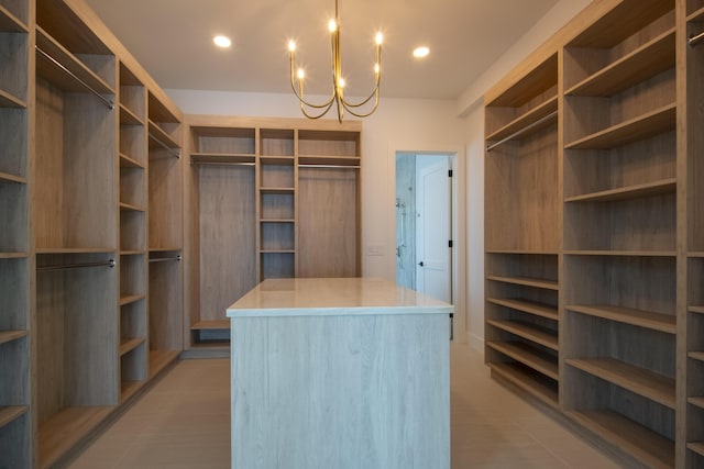 walk in closet featuring a chandelier