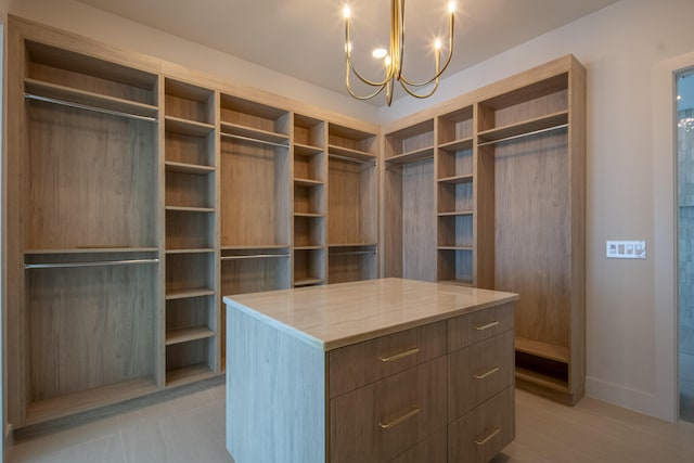 spacious closet featuring a notable chandelier