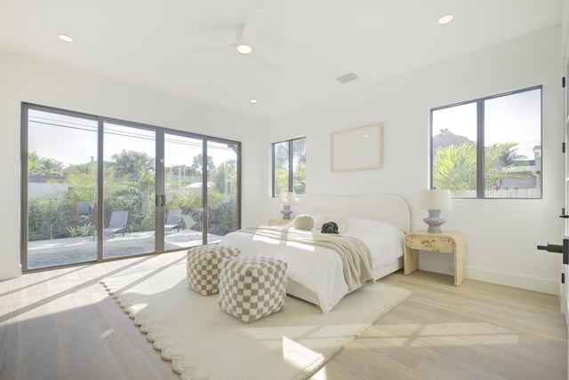 bedroom featuring ceiling fan, light hardwood / wood-style floors, and access to outside