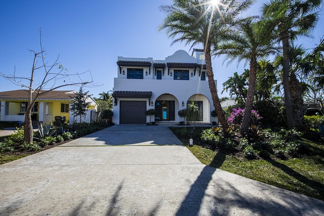 mediterranean / spanish house featuring a garage